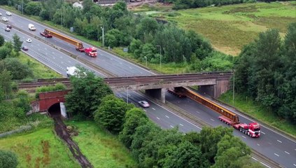 Network Rail reveals drone footage of two 42-metre beams being delivered to the M62 worksite ahead of the £22m+ Castleton bridge replacement