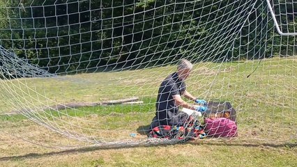 Fox rescued from football net