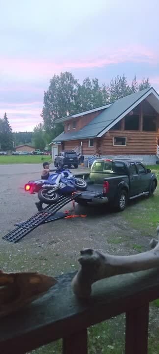 Woman Falls Along With Bike While Loading it to Pickup Truck