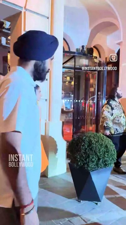 Radika and Anant Exit their hotel in Paris.