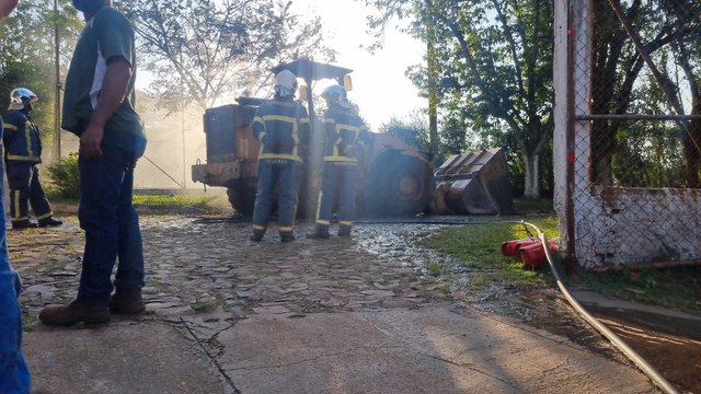 Pá carregadeira pega fogo e Corpo de Bombeiros contém chamas