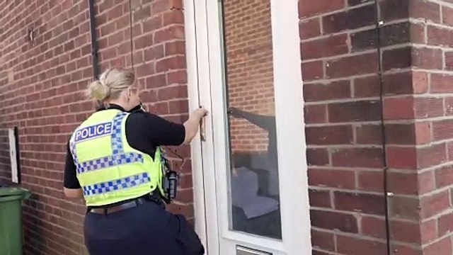 Police officers breakdown door to arrest further people following yesterday's disorder in Sunderland