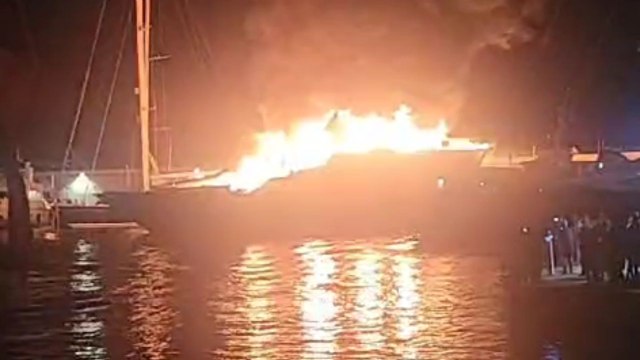 Man captures harrowing footage of yacht fully engulfed in flames at night