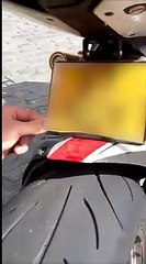 Police demonstrate 'flip up' plate on bike