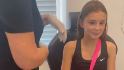 Excited girl experiences nervousness during the first ear piercing and loves the result