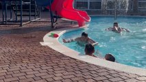 Little girl's pool slide ends with her unexpectedly landing on dad