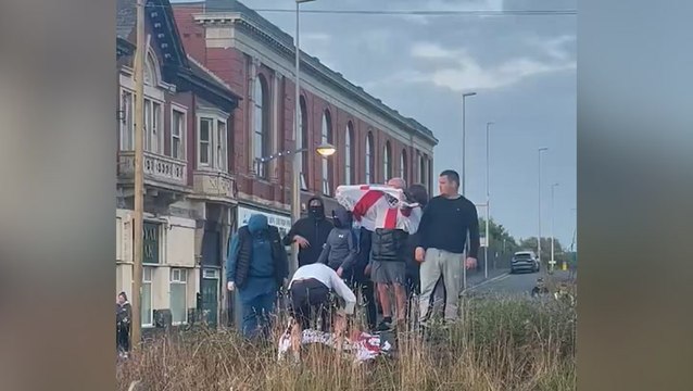 Masked far-right rioters occupy roundabout surrounded by counter-protesters