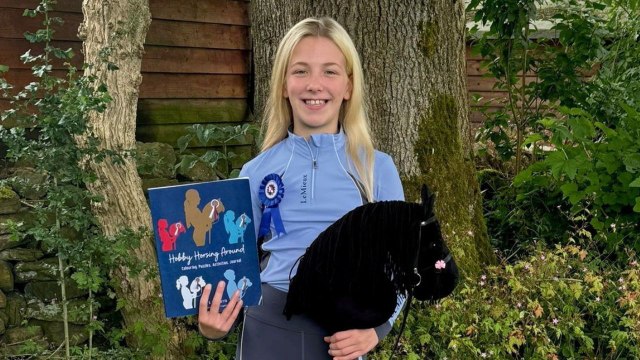 Girl competes in hobby horse competitions where she show jumps with stick pony