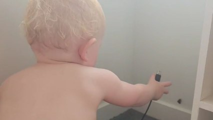 Toddler grabs a cord to play with a moth, doesn't like it when moth plays back