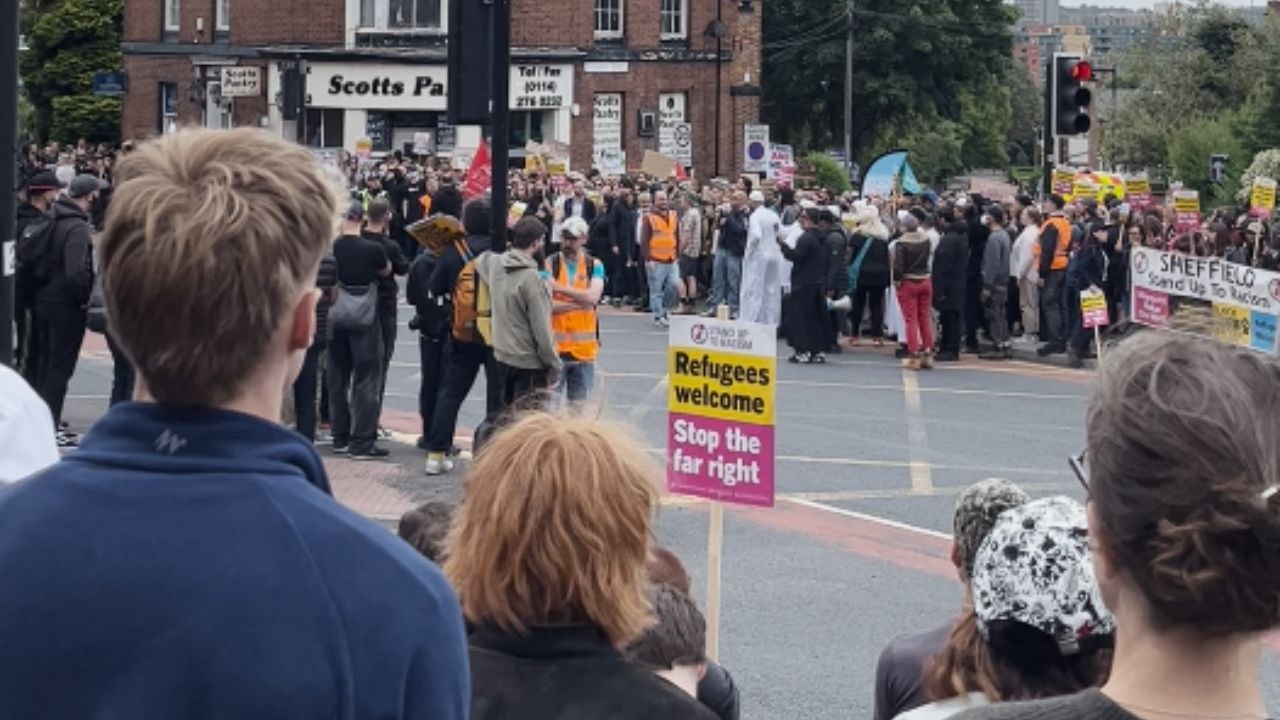 Large crowd of anti-racism protesters protects a visa site against rioters in Sheffield