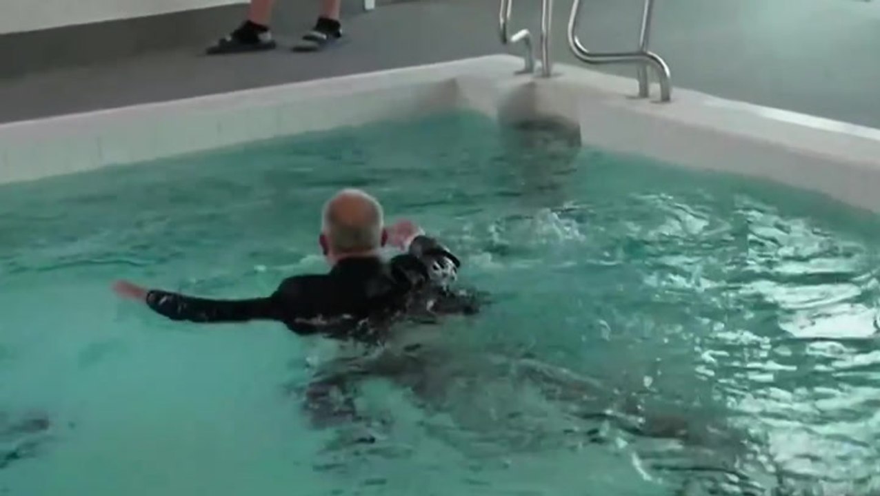 Reporter goes for gold as he dives into pool fully-clothed on live TV