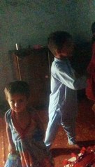 A little boy trying to perform some action without sound