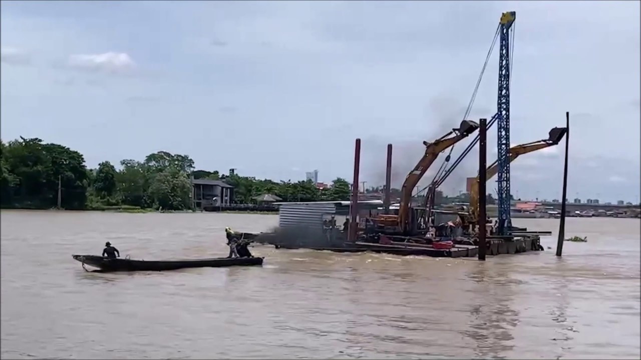Tractors are being transported on a boat on the Chao Phraya River, Koh Kret, Thailand.