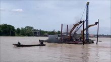 Tractors are being transported on a boat on the Chao Phraya River, Koh Kret, Thailand.