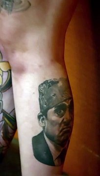 She's holding a Dundie she won for best office tattoos. She also had an amazing Dwight tattoo on her other leg but I need to find that video