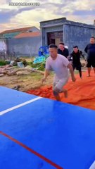 Homemade Olympic games air cushion long jump in rural areas simple happiness of man
