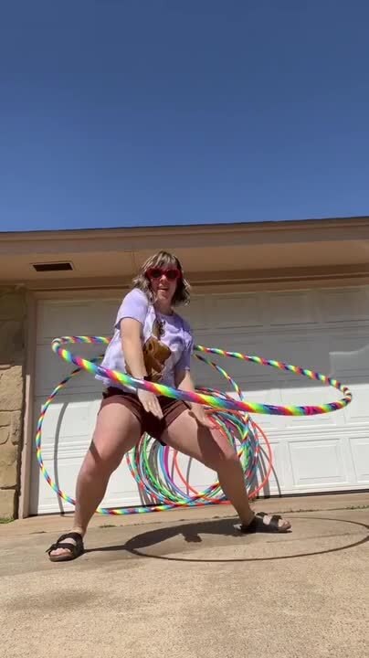 Woman Skillfully Hula-Hoops With Giant Foldable Hoop