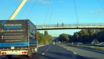 Man hangs out of van being driven along M20