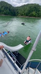 Person Falls Into Water While Trying to Take Jet Ski Down Houseboat Slide
