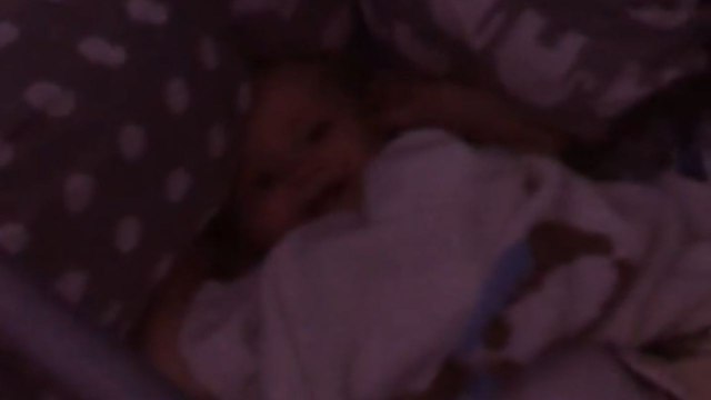 Mom blows the air horn and causes the little boy to burst into joyful giggles