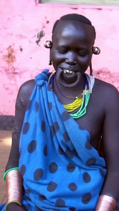Woman from Surma tribe inserts lip plate _ Omo Valley Ethiopia #shorts