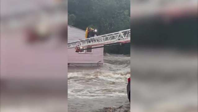 Firefighters use ladder as bridge to rescue 19 people from restaurant surrounded by rushing water