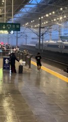 The railway station is drenched with heavy rain and strong winds, causing luggage to roll across the slipp...and relentless downpour make for a challenging and chaotic scene as travelers struggle to stay steady and manage their bel