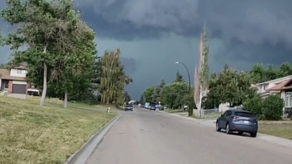 Calgary, Canada: Floodwater flows through street following INTENSE hailstorm