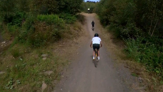 Riders entangled in a crash after a slowing rider lost control on jumps