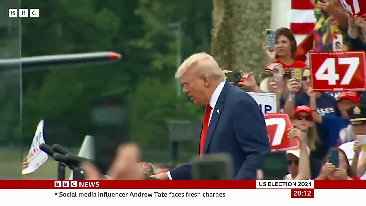 Donald Trump stands behind bullet-proof glass at first outdoor rally since he was shot  BBC News