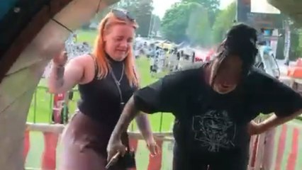 Woman loses balance right after stepping on funhouse wheel, drags friend with her too!