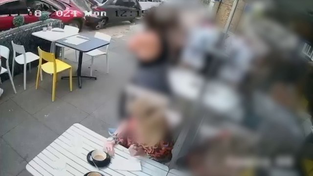 Two cars crash onto pavement narrowly missing café customers