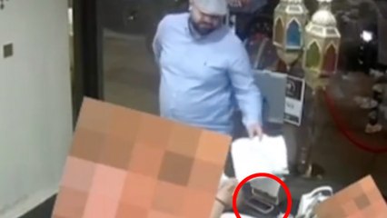 Moment brazen 'thief' distracts diners with paper as he 'swipes phone'