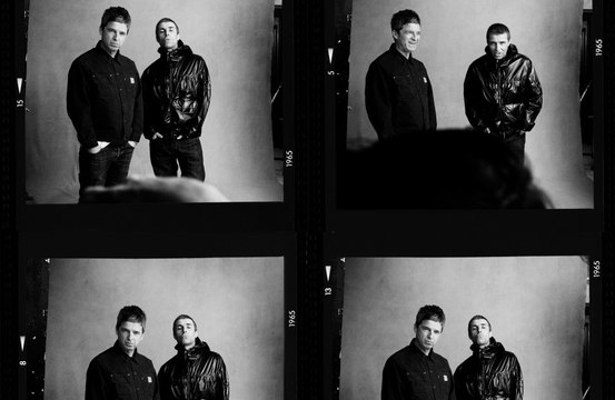 Noel and Liam Gallagher can be seen smiling together in new images released by Oasis