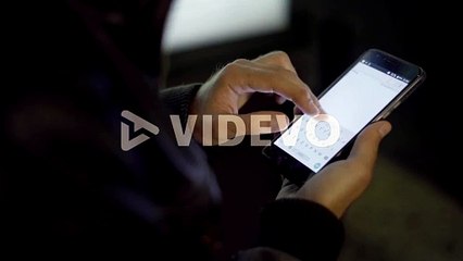 Adult man networking smartphone in night city