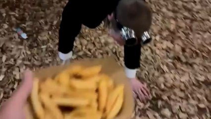 Festival humor: Drunk man in formal attire eats chips with enthusiasm