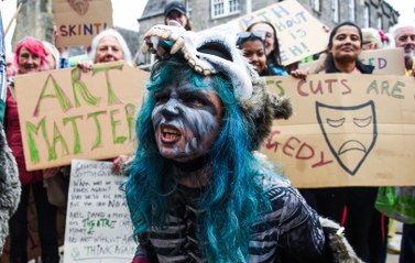Demonstrators protest outside the Scottish Parliament over proposed government cuts
