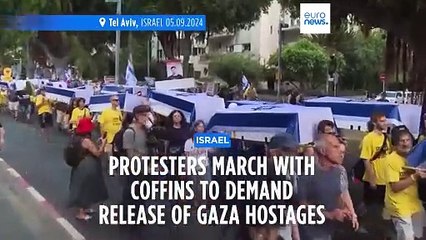 Protesters march in Tel Aviv with makeshift coffins to demand release of Gaza hostages