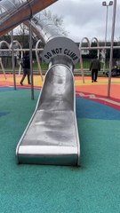 Adorable toddler finds himself in the way of girl zooming down the slide