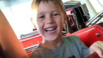 Excited little boy rides train rollercoaster fearlessly during family vacation