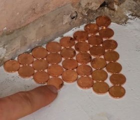 Decorating old bathroom floor with coin mosaic!