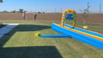 Family Slip N' Slide turns chaotic with overconfident grandpa's adventurous attempt
