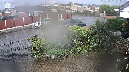 Lightning hits house and cars submerged as storms strike Britain