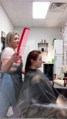 Hairstylist is trying to prank her client with a huge comb, but she doesn't notice!