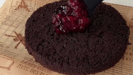 Talented baker prepares fudgy chocolate cake with mascarpone frosting and wild berry jam