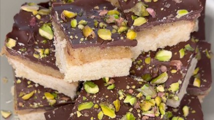Man shows the technique for crafting nutty pistachio millionaire's shortbread with elegance
