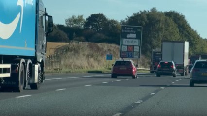 Glider resembling a flying car swoops over motorway, leaves woman confused