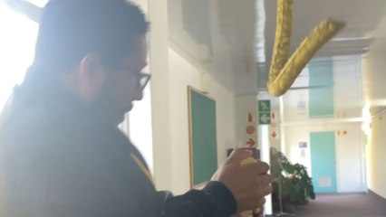 Girl pranks her co-workers with snake can and enjoys their reactions