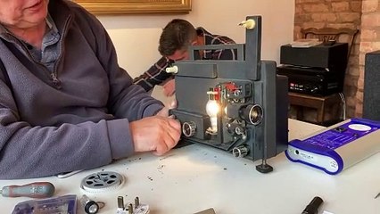 Ian Barnard showing how projector operates (Will Goddard, Crediton Courier)