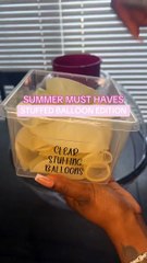 Person is placing gift items into a balloon!